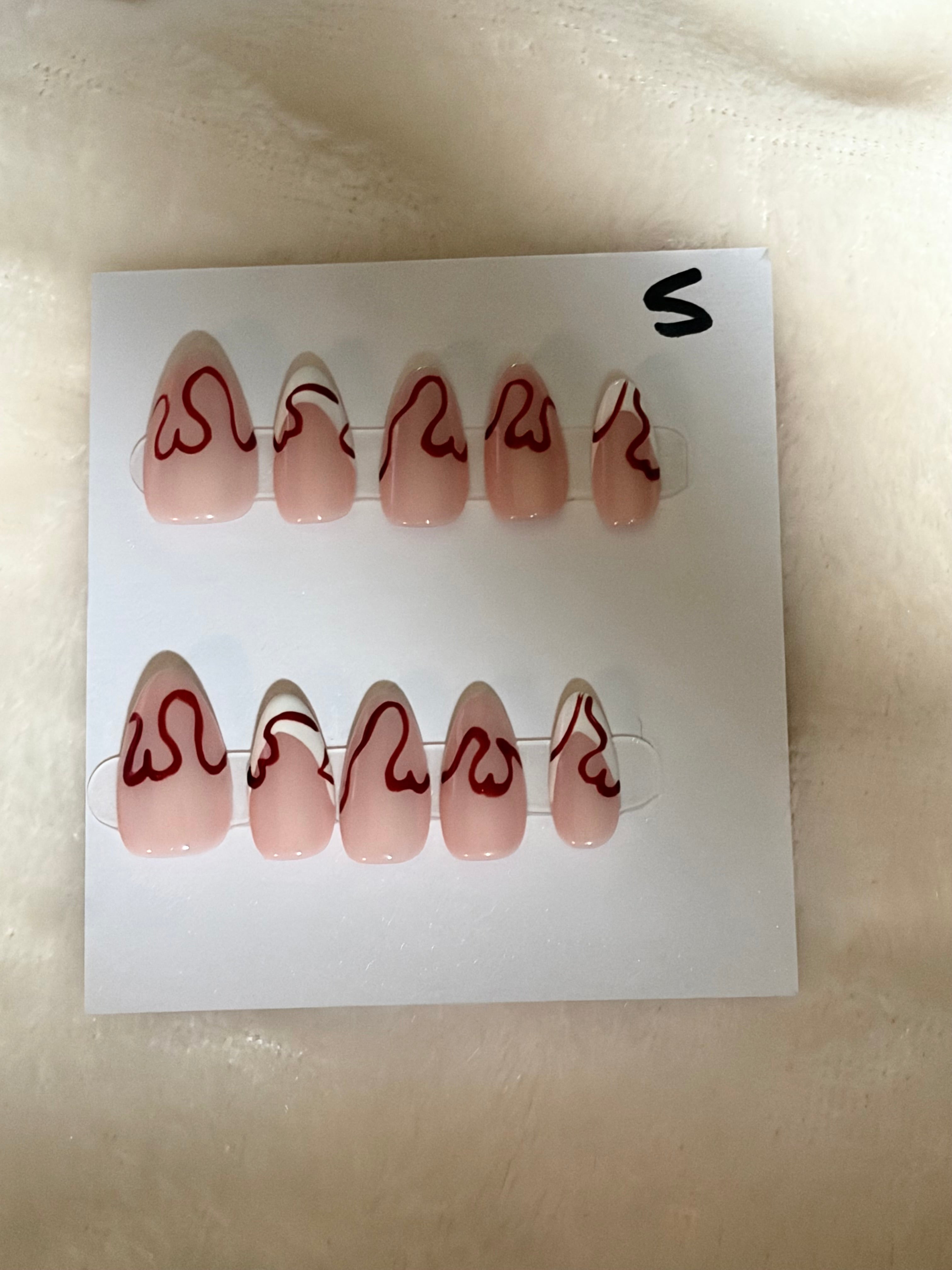 Short, almond shape, red design-$10